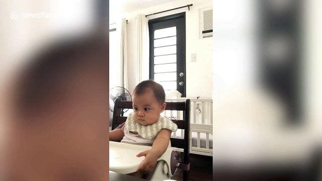 Sleepy Filipina baby tries to stay awake while eating her favourite food