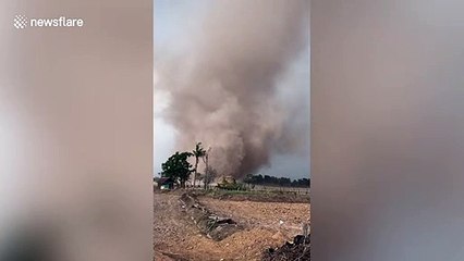 Huge tornado sweeps through farmer's field in rural Thailand