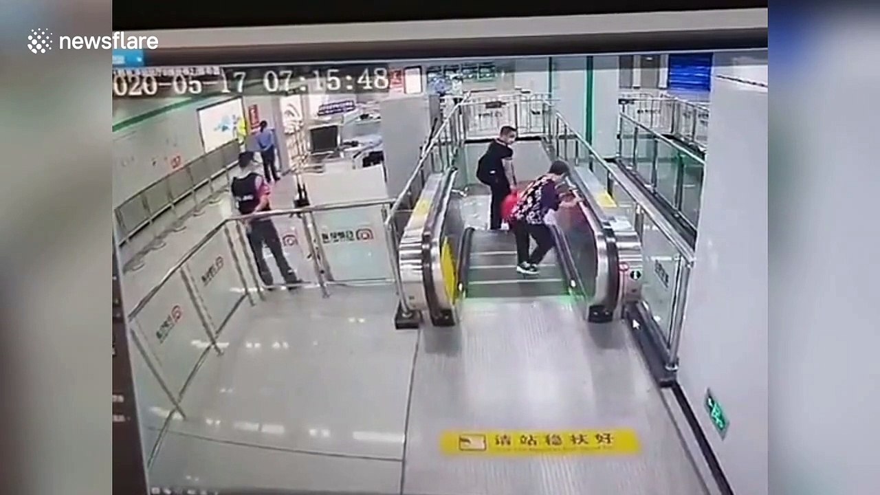 Chinese policeman hops over glass railing to stop escalator after elderly woman falls over on it