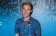 Gary Barlow shows off his weight loss as he poses in old blazer from 2003
