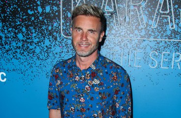 Gary Barlow shows off his weight loss as he poses in old blazer from 2003