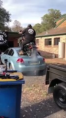 Biker Does Burnout on Back of Car