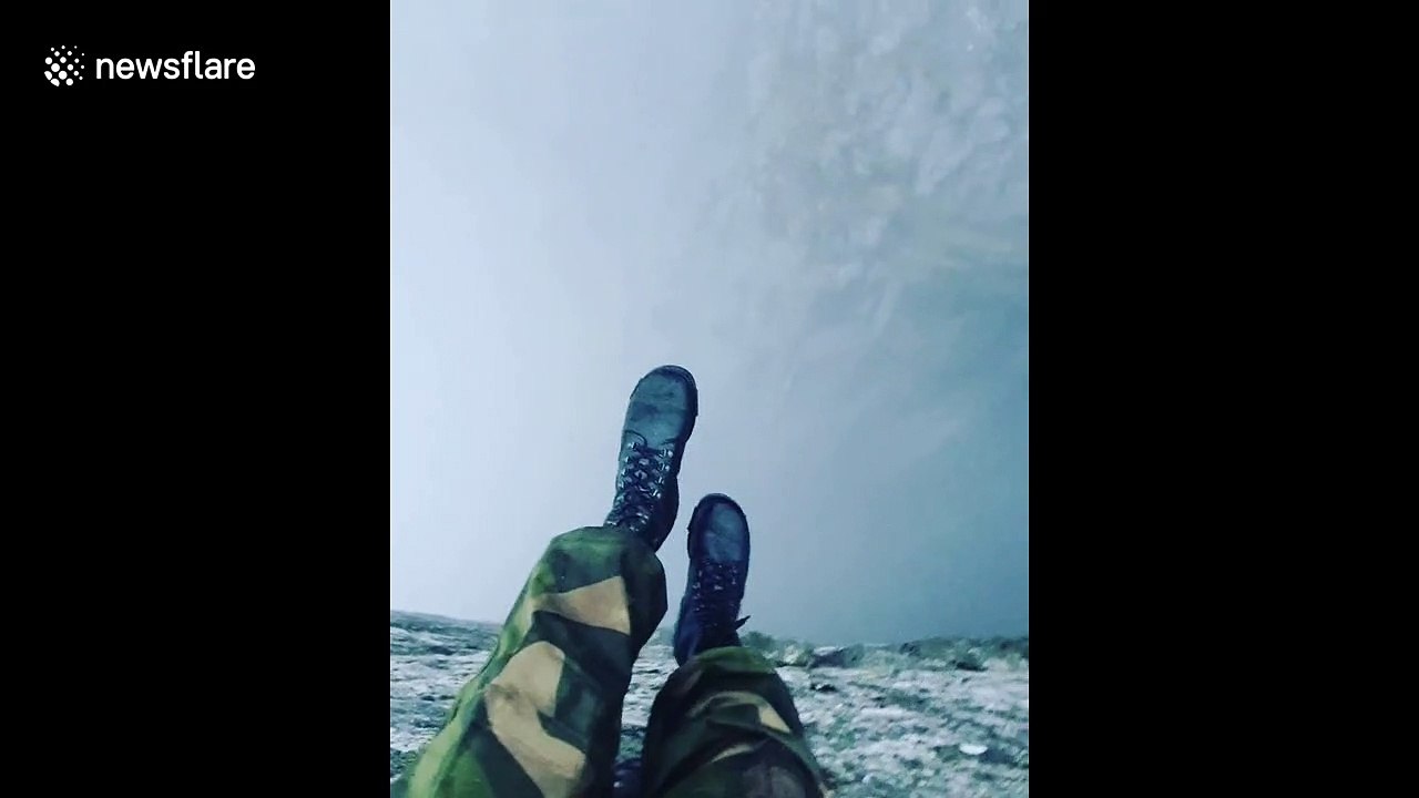 Man dangerously dangles legs off of 2000 feet DROP in Norway