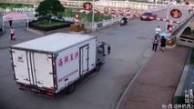 Chinese woman narrowly escapes being hit by height restriction barrier after truck knocks it down