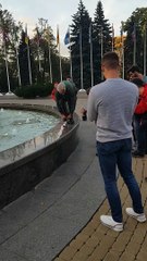 Man Rides a Tiny Bike on a Fountain