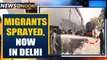 Migrants sprayed with disinfectant in South Delhi, authority says 'mistake' | Oneindia News
