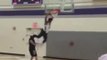 One Player Jumps Over Another And Dunks Ball in Basket While Basketball Game