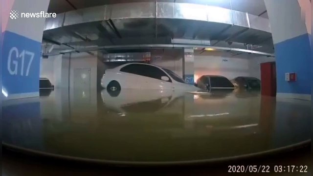 Car accurately floats into parking spot as floodwater submerges underground garage