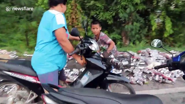 Truck spills hundreds of cans of beer sparking frenzy as locals try to collect them