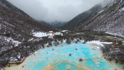 Unexpected snowfall blankets China’s Huanglong valley
