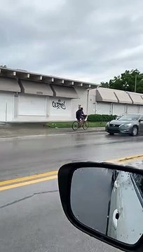 Dog Hitches a Ride on Bicycle Riders Back