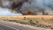 Dry, gusty wind sweeps wildfire flames