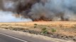 Dry, gusty wind sweeps wildfire flames
