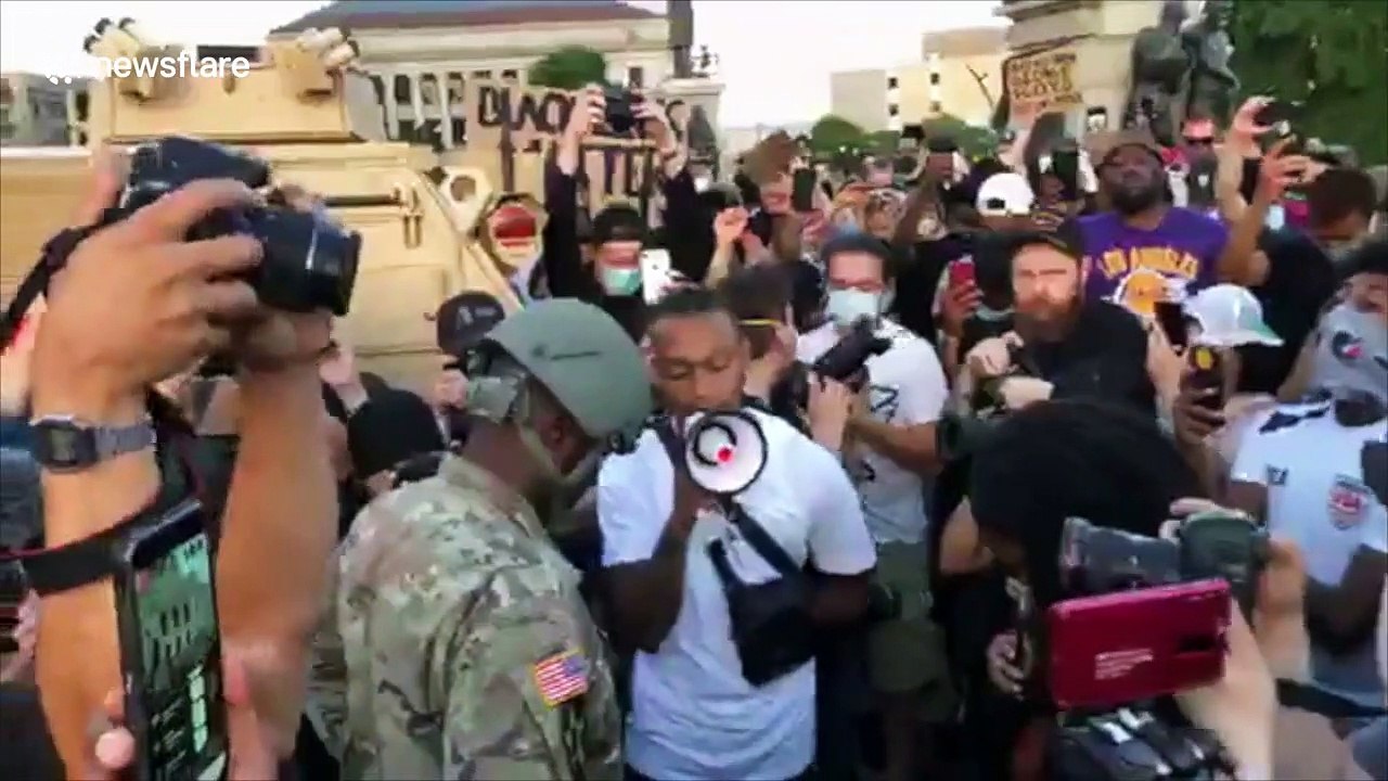 National Guard soldier prays and hugs protesters at Minnesota rally