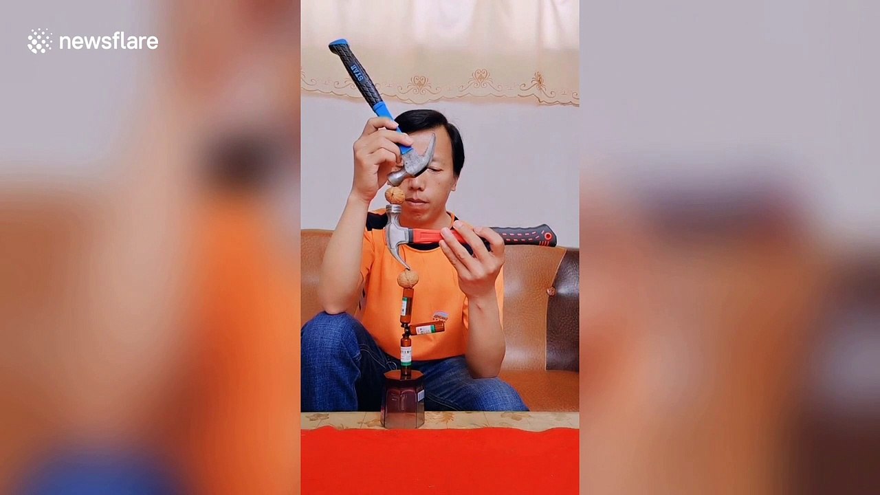 Talented Chinese man shows off incredible balancing skills using hammers and walnuts