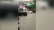 Vehicles trapped on Thai road submerged by deep floodwater