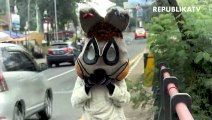 Pengamen yang mengenakan badut kelinci beraktivitas di jembatan kawasan Jakarta Timur.