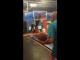 Guy Fails and Falls While Playing Basket Ball in Trampoline Park