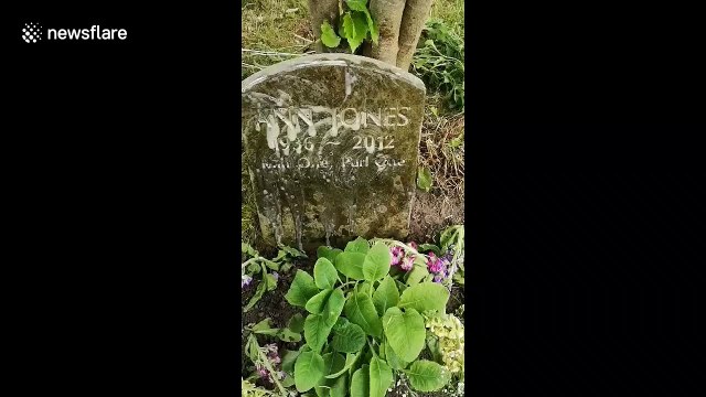 A man and his children are cleaning gravestones in local cemeteries in Cheshire, northwest England
