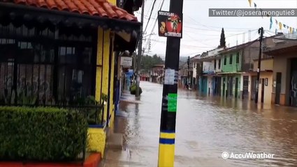 Endless floodwaters flow down street in village