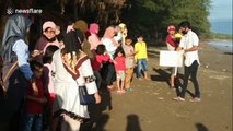 Adorable moment Indonesian children release hundreds of baby sea turtles for Word Environment Day