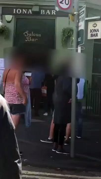 Drinkers outside pub in Easter Road