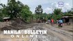 Residents in Batangas dug wet ashes that blocks their main roads