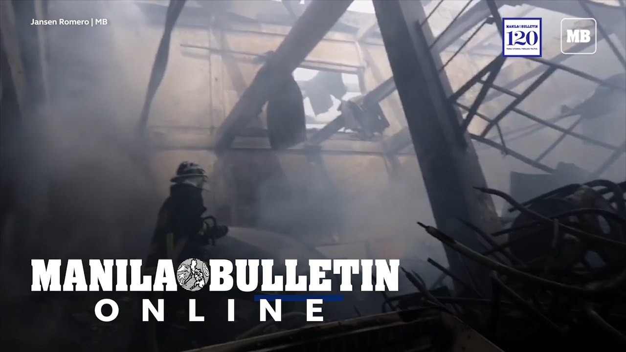 Fire fighters extinguishing the remaining fire that razed three warehouse at Potrero, Malabon City