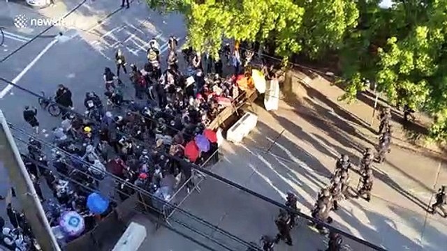 Clashes as police surround Black Lives Matter protesters in Seattle before forcing them to move using flashbang grenades and pepper spray