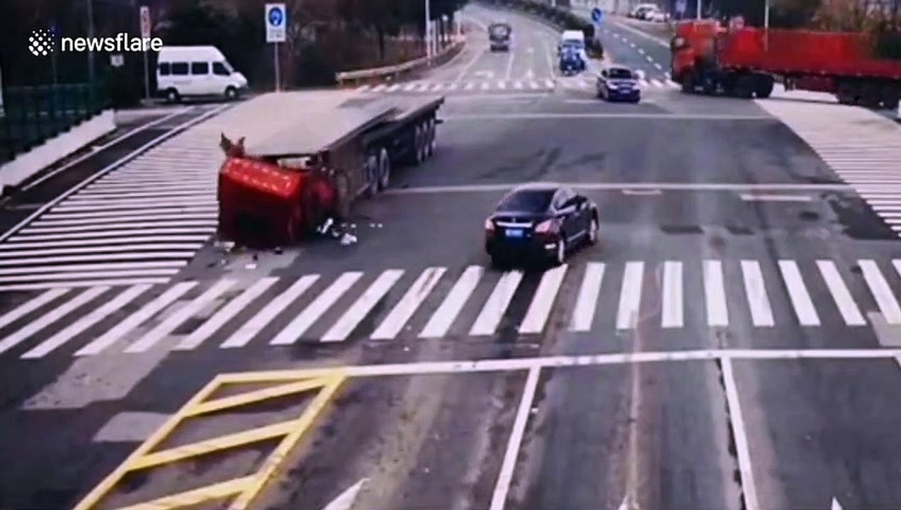 Truck cabin flattened by steel plates loaded on trailer after vehicle performs emergency stop