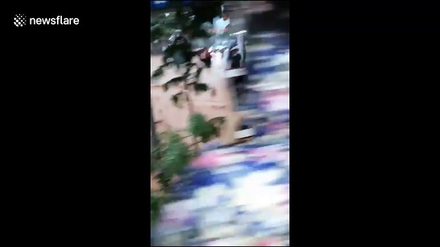 Vehicles and pedestrians struggle to navigate through flash floods in Vietnam