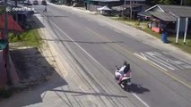 Thai motorcyclist knocked over by metal girders carried by workers crossing road