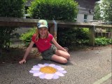 Children have drawn chalk flowers on playground to cheer people up