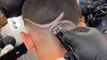 Barber cuts slick freestyle hair design