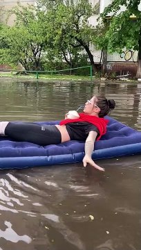 Relaxing on A Float Down A Flooded Street