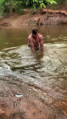 Man Catches Enormous Fish with his Bare Hands