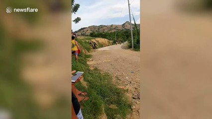 Man has shocking near-death crash downhill racing motorbike in Philippines