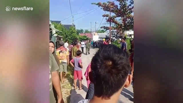 Military plane crashes into homes in Indonesia as pilot ejects