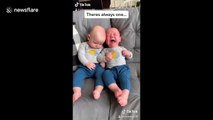 Chilled baby is totally fed up by his identical twin brother's crying