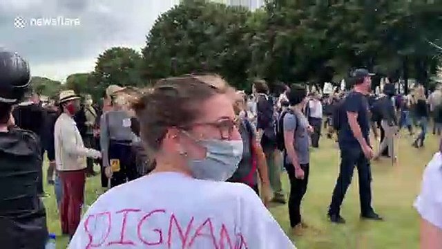 Police officers drag wounded colleague away during clashes in Paris