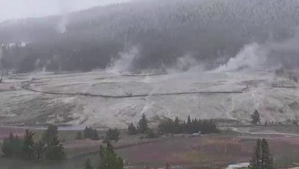 Snow falls over Yellowstone's steamy landscape