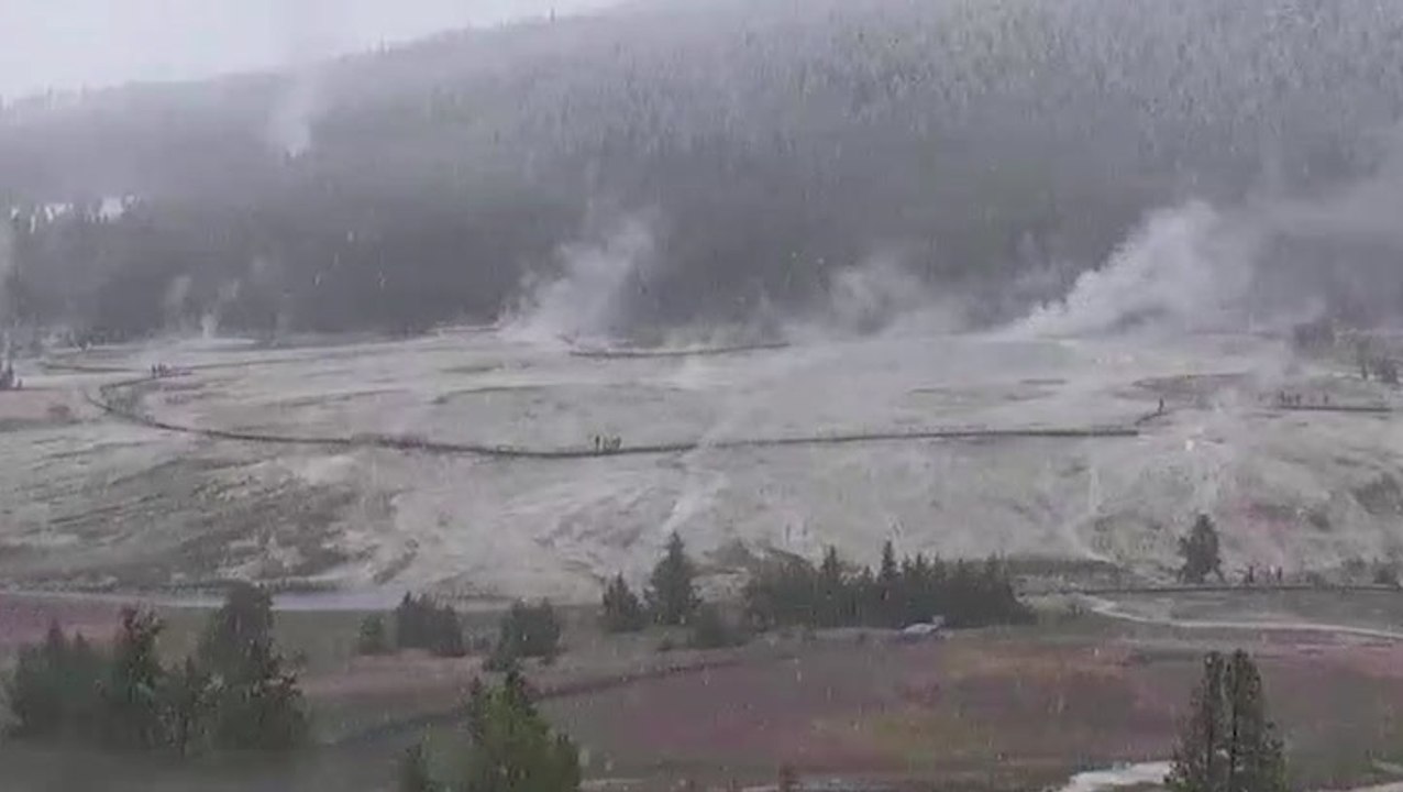 Snow falls over Yellowstone's steamy landscape