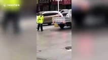 Motorist drives off with police officer on bonnet to avoid inspection in China