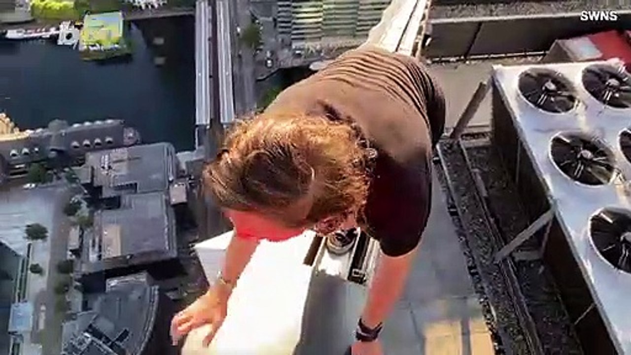 Daredevil Teen Casually Hangs One-Handed Off th...