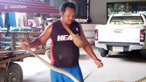 Snake wranglers ride away with reptile carried around their neck
