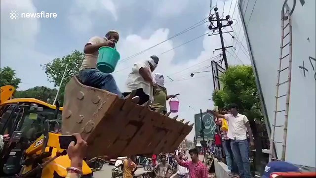 Indian politician and supporters deface billboard advertising Chinese products in Bihar