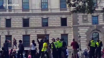 Woman seen standing on van with fist in the air driving alongside the Black Lives Matter protests in London