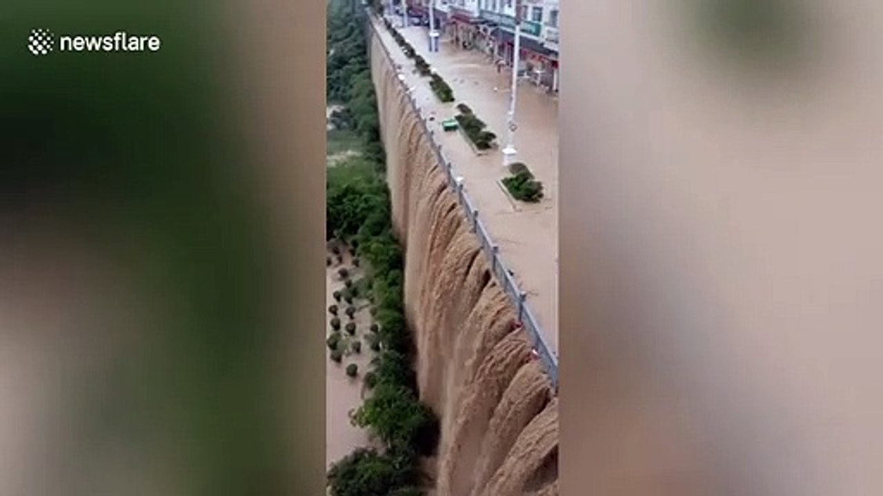 Rainfall causes flood and creates waterfall on bridge in southern China
