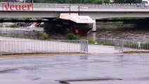 Flooded River Puts Boats on Destructive Crash Course with Highway Bridge