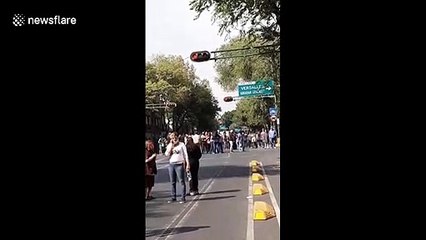 Residents of Mexico City evacuate buildings after powerful earthquake hits southern Mexico